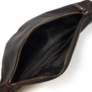 Detailed view of genuine leather waist bag interior showing multiple pockets and zippers.