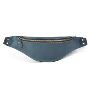 Close-up detail of vintage genuine leather waist bag with brass zipper and rivets.