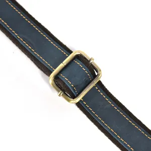 Detailed shot of genuine leather bag strap with metal buckle and stitching replacement.
