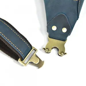 Close up shot of retro blue leather chest bag metal buckle and strap details, durable quality.