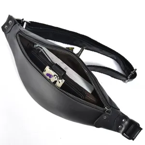 Detail view of the black leather waist bag showing open zipper compartment and internal capacity.