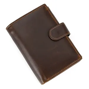 Brown leather trifold wallet detail view featuring fine stitching and secure snap closure