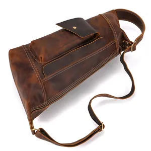 Detail view of vintage crazy horse leather chest bag, showing texture and hardware stitching.