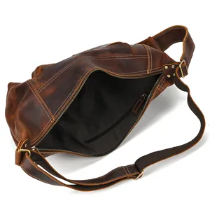 Leather chest bag detail view showing internal zipper pocket, spacious compartment, vintage style.