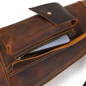 Close-up detail of vintage crazy horse leather chest bag zipper pocket and texture.