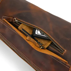 Detailed view of vintage crazy horse leather chest bag, showing zipper pocket and cowhide texture.