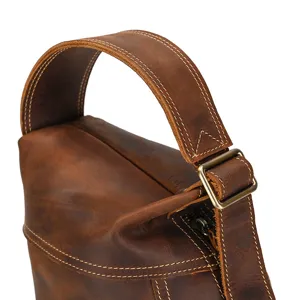 Close-up of retro crazy horse leather chest bag handle and strap detail craftsmanship.