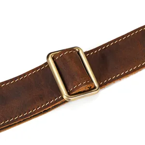 Detailed view of genuine crazy horse leather vintage bag adjustable strap with durable metal buckle.