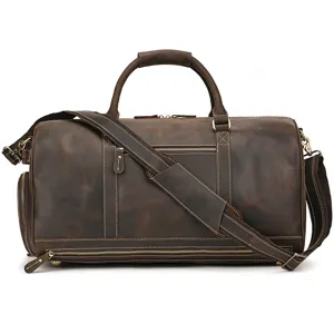 Vintage dark brown leather travel duffel bag with shoulder strap and multiple storage pockets.