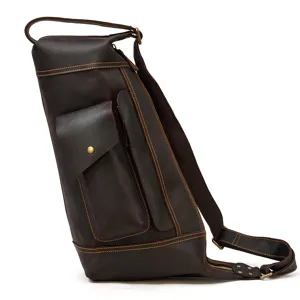 Vintage dark brown leather sling bag detail showcasing sturdy stitching and front pocket design.