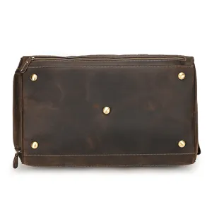Detailed view of the genuine crazy horse leather travel duffel bag bottom with metal feet.
