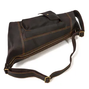 Vintage brown genuine leather chest bag detail, men's sling bag with metal zippers and strap.