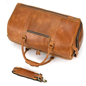 Leather travel duffel bag detail, vintage brown luggage compartment and shoulder strap view.