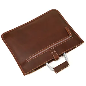 Vue détaillée de la mallette d'affaires en cuir marron avec poignée en métal et fermeture.