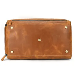 Vintage genuine crazy horse leather travel bag bottom detail showcasing metal feet.