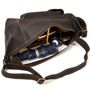 Detail view of large capacity vintage brown leather messenger bag interior storage capacity.