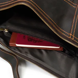 Vintage brown leather chest bag interior detail, durable metal zipper and spacious pocket.