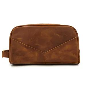 Detailed view of genuine leather travel toiletry bag with zipper and side handle.