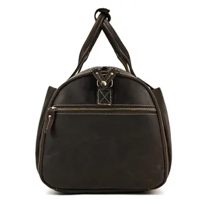 Detailed view of vintage dark brown leather travel duffel bag showing metal zippers.