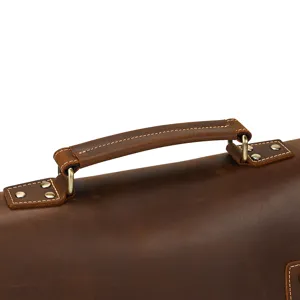 Detail shot of vintage crazy horse leather briefcase handle, sturdy brass hardware and stitching.