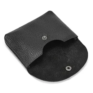 Black leather coin purse detail showing premium cowhide texture and metal snap button closure.