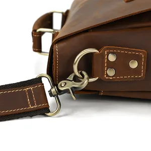 Detailed view of men's genuine leather briefcase strap buckle in vintage brown style.