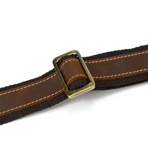 Genuine leather canvas bag shoulder strap detail view, vintage metal adjustable buckle accessory.