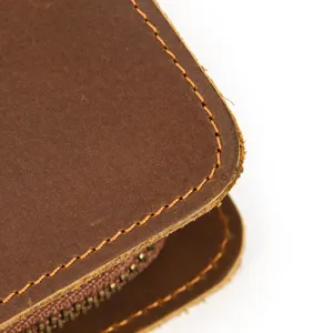 Crazy horse leather wallet detail close-up showing fine stitching and premium retro brown texture.