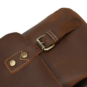 Close-up detail of vintage crazy horse leather men briefcase metal buckle stitching.