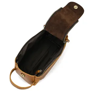 Detailed interior view of a vintage genuine leather toiletry bag with sturdy metal zipper.