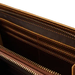 Genuine leather wallet interior detail showing multiple card slots, smooth zippers and fine stitching.