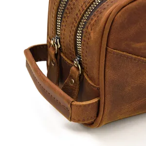 Close-up detail of vintage brown crazy horse leather toiletry bag double zipper design.