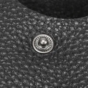 Genuine leather coin purse snap button detail close up black texture wallet hardware