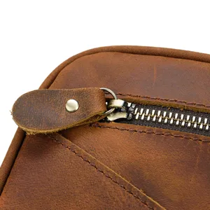 Vintage genuine crazy horse leather toiletry bag detail showing metal zipper and pull tab.