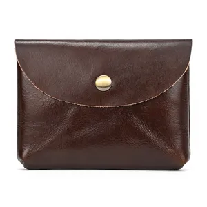 Close-up view of genuine leather snap coin purse, showing cowhide texture and metal button details.