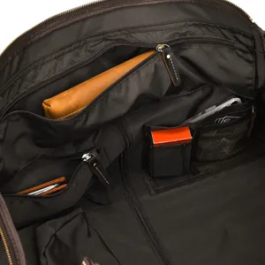 Interior detail of vintage leather travel bag with multi pockets and zip compartments.