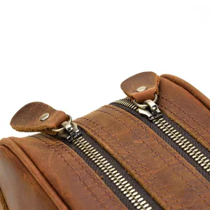 Close-up detail of retro crazy horse leather double zipper travel wash bag cosmetic organizer.