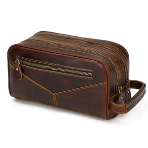 Vintage leather toiletry bag detail closeup showing double zipper and sturdy side handle design.