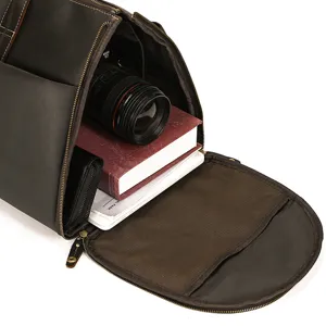 Detailed view of the dark brown genuine leather travel duffel bag interior capacity storage.