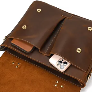 Leather briefcase interior detail showing multi pockets and premium vintage brown material.