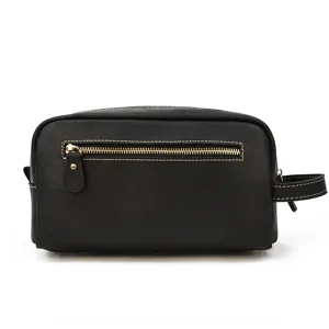 Close-up of black genuine leather toiletry bag detail, showcasing retro style and metal zipper.