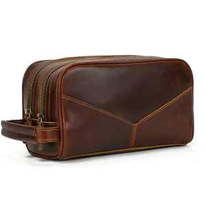 Detail view of the vintage genuine leather toiletry bag featuring durable double metal zippers.