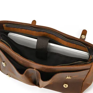 Vintage brown leather laptop briefcase detail shot, showcasing spacious interior compartments.