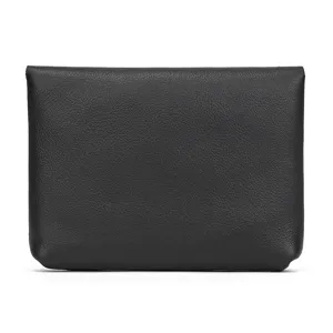 Close-up detail of a minimalist black leather coin purse and card holder with smooth texture.