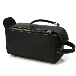 Genuine leather vintage toiletry bag detail, black waterproof travel cosmetic storage pouch.