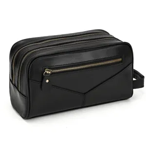 Detailed view of the black genuine leather toiletry bag featuring multiple smooth metal zippers.