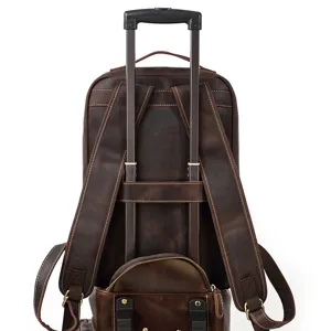 Leather backpack trolley strap detail showing durable stitching and dark brown crazy horse leather.