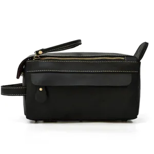 Black genuine leather toiletry bag detail, vintage clutch zipper pocket design close-up view