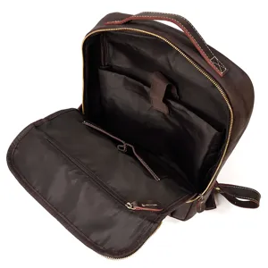 Detailed interior view of the dark brown leather backpack showing compartments and zipper pocket.