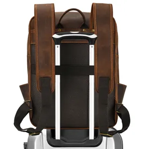 Detail view of brown vintage leather backpack featuring a convenient luggage strap for travel.